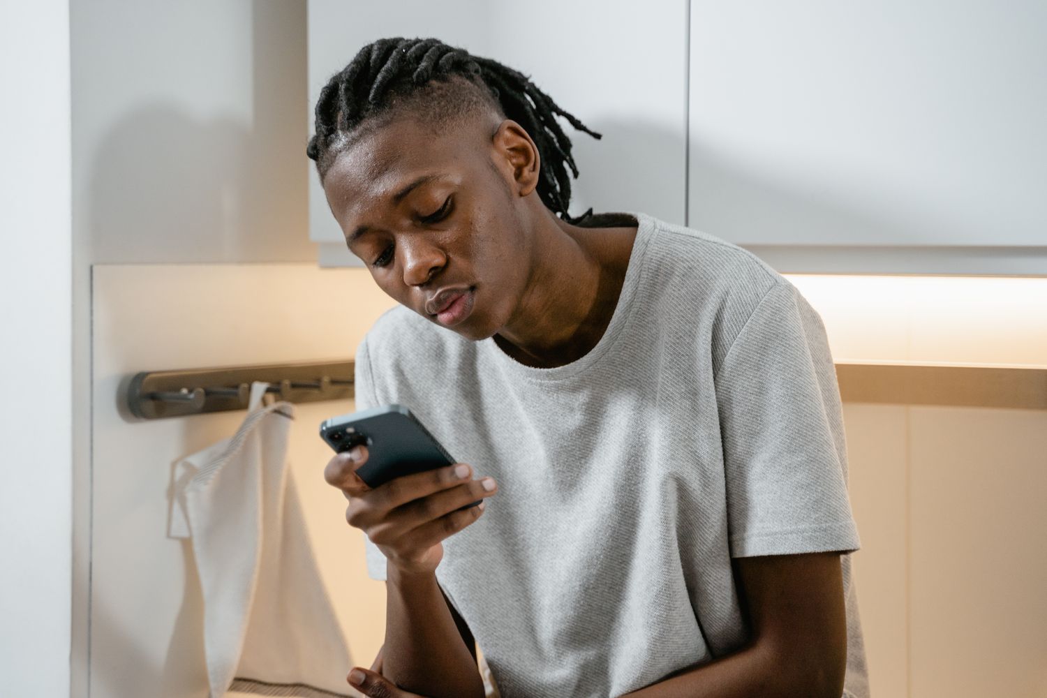 Someone following a guide on their phone in a kitchen